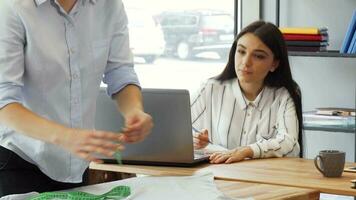 Team of fashion designers working together at the office video