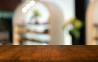 Empty wooden table in front of abstract blurred background of coffee shop . can be used for display or montage your products.Mock up for display of product photo