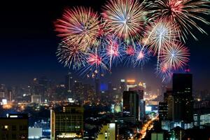 Amazing beautiful colorful fireworks display on celebration night, showing on the sea beach with multi color of reflection on water photo