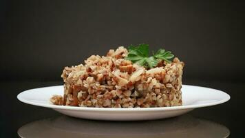 cooked buckwheat boiled with mushroom filling in a plate video