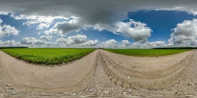 360 hdri panorama on gravel road with marks from car or tractor tires with clouds on blue sky in equirectangular spherical  seamless projection, skydome replacement in drone panoramas photo