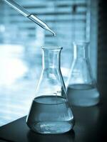 Laboratory glassware at lab background in blue tone photo