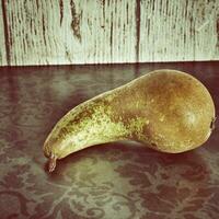 still life with pears on a wooden background photo