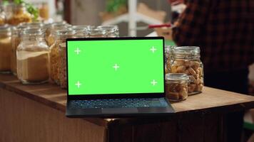 krom nyckel bärbar dator med kopia Plats Begagnade som kommersiell tecken i låg kol fotavtryck lokal- affär. PR ad på grön skärm enhet i mat Lagra med Produkter i återvinningsbar glas behållare video