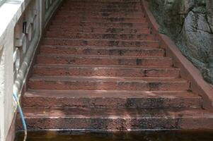 old cement stairs There are traces of use for a long time and there is a crack in the floor photo