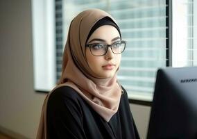 Pretty woman in sunglasses and hijab working at computer. Generate Ai photo