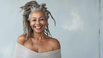 Happy mature african woman smiling cheerfully embracing her natural body with dreadlocks with copyspace AI Generated photo