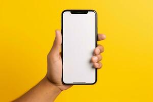 Closeup hand holding mobile phone mockup in yellow plain background ai generative photo