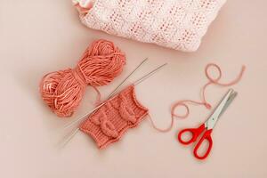 knitting with the word love, scissors and a finished knitted product photo