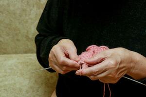 hands of senior woman knitting photo