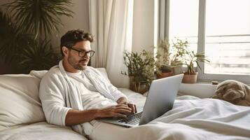 Man lying on bed using laptop computer while working in hotel room as travel business concept AI Generated photo