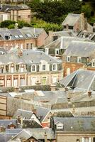 a view of the roofs of a town in france photo