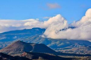 a mountain range and clouds photo