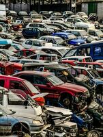 a large lot of cars are piled up in a parking lot photo