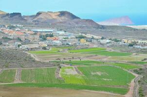 aerial view of fields and a city photo