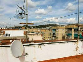 a rooftop with a satellite dish and a television photo