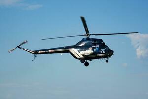 Hungarian government police helicopter at airport and airfield. Rotorcraft. General aviation industry. Police utility transportation. Air transport. Fly and flying. photo