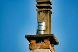 a chimney with a metal chimney cap photo