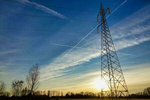 electricity pylons in the field photo