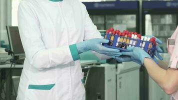 Cropped shot of a medical worker receiving blood test samples from a colleague video