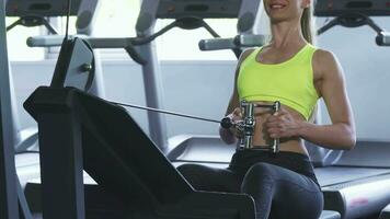 Cropped shot of a sportswoman exercising on seated cable row machine video