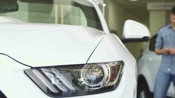 Young couple shopping for a new automobile at the delership saon video