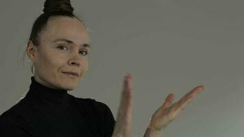 a woman in a black shirt is gesturing with her hands video