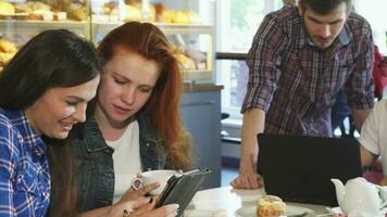 Group of young friends having breakfast together using gadgets video