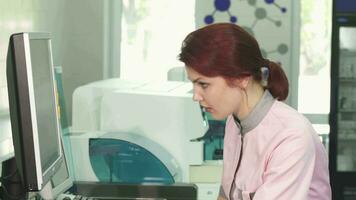 Beautiful young woman working at the laboratory video