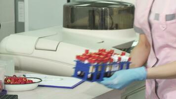 Cropped shot of a scientist taking notes while working with blood samples video