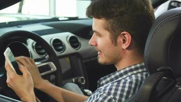 Close up shot of a handsome man sitting in his convertible, smiling joyfully video