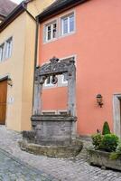 a well in the middle of a cobblestone street photo