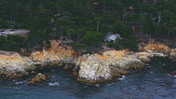 Aerial view of the Pacific Ocean waves hitting the cliff rocks. Top view of the waves. Sea shore during the storm. video