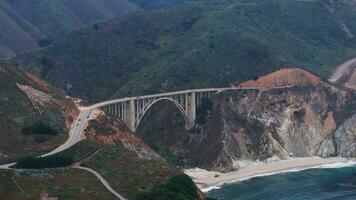 The Pacific Ocean washes onto the beautiful seashore of California, not far south of Monterey. Aerial shot of Bixby Creek Bridge on the Big Sur coast of California. video