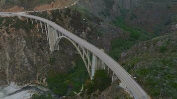 de grote Oceaan oceaan wast op de mooi kust van Californië, niet ver zuiden van Monterey. antenne schot van bixby kreek brug Aan de groot sur kust van Californië. video