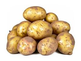 Heap of young potato isolated on white background with clipping path included. Organic potato right from the garden photo