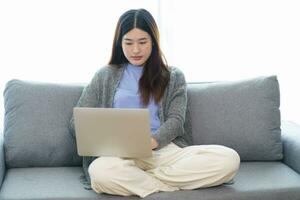 Happy beautiful Asian Woman. Business woman working from home wi photo