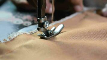 Close up Senior Female Tailor Sewing fabric into cloth, tailor hand, sewing machine, elder concept video