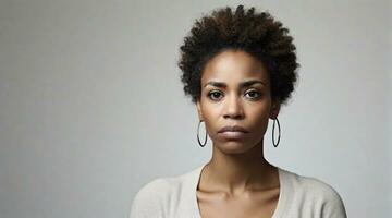 Portrait of an afro-american woman with a deep sad expression  against white background, background image, AI generated photo