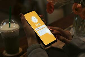 Evaluating quality and service of restaurants. Customers using smartphones select a fair level, normal emojis. Concept of store development from recommend and evaluation photo