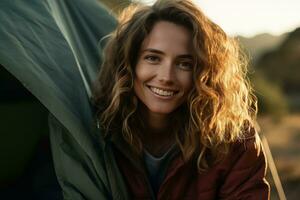 Portrait of girl looking at camera while near camping tent at sunset AI generated photo