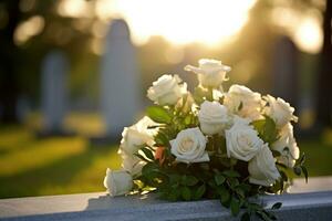 blanco flores en frente de un lápida sepulcral a un cementerio con atardecer.funeral conceptualizado generado foto