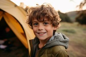 Portrait of a cute boy looking at camera while near his tent in nature AI generated photo