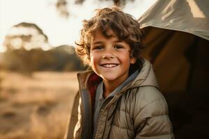 Portrait of a cute boy looking at camera while near his tent in nature AI generated photo