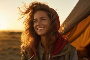 Portrait of girl looking at camera while near camping tent at sunset AI generated photo