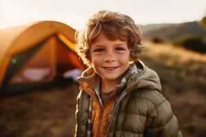 Portrait of a cute boy looking at camera while near his tent in nature AI generated photo