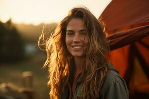 Portrait of girl looking at camera while near camping tent at sunset AI generated photo