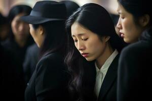 Asian woman in mourning at a funeral, shallow depth of field.Funeral Concept AI generated photo