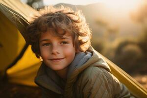 Portrait of a cute boy looking at camera while near his tent in nature AI generated photo