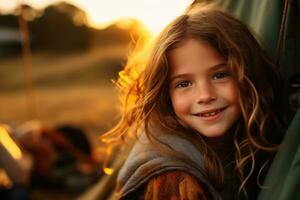 Portrait of cute little girl at camera while standing near camping tent at sunset AI generated photo